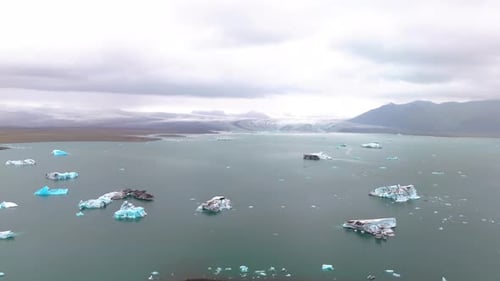 Scenic aerial landscape view of glacier lake with icebergs in Iceland.