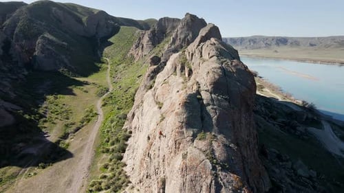 Man Athlette Climbing on the High Rock