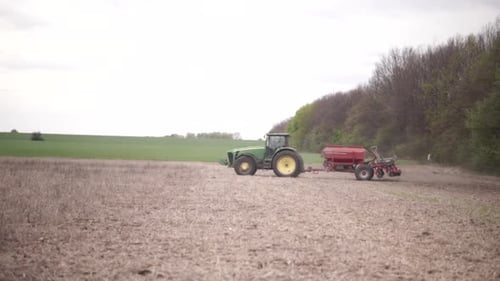 farmer on the field during planting corn and checking the soil