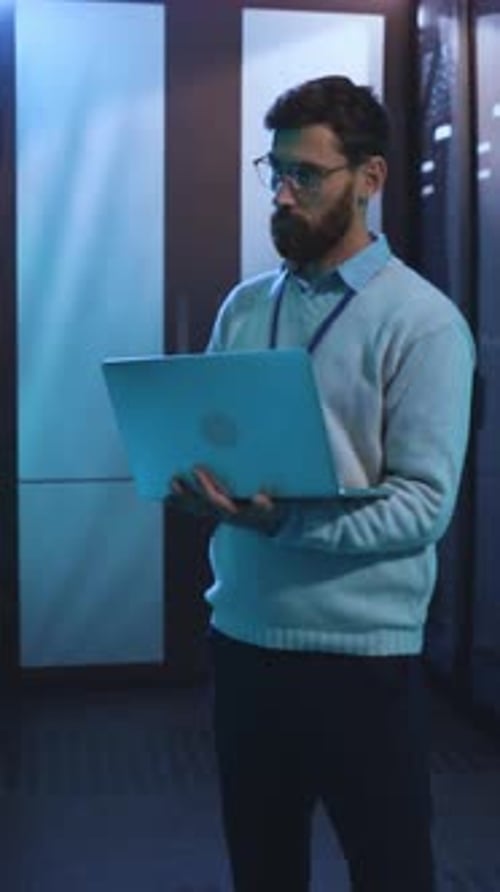 A Man Uses His Laptop in a Modern Office Showcasing Productivity and Focus While Working