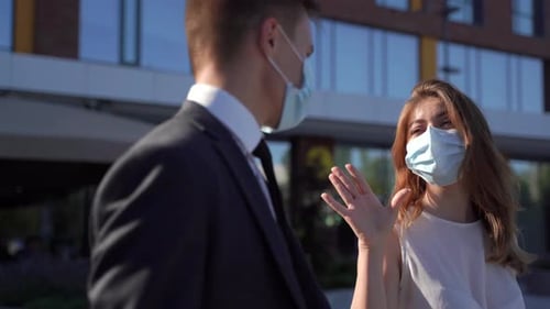 Business People Wearing Masks Talking Outside Office Building