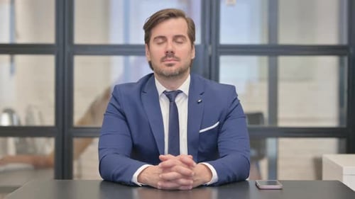 Serious Young Businessman Looking at Camera