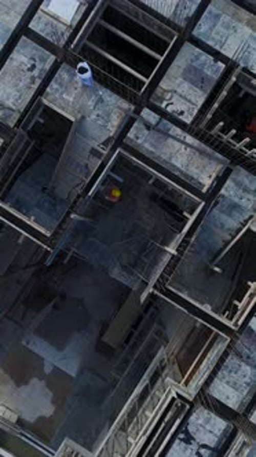 Vertical Video Aerial View of Construction Workers Preparing Scaffolding and Framework for New