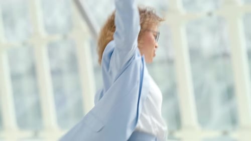 A Young Woman Enjoys Smiling While Utilizing a Notebook in an Outdoor Urban Workplace