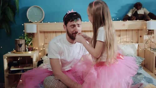 Dad and Daughter Play Dressing Up in Bedroom