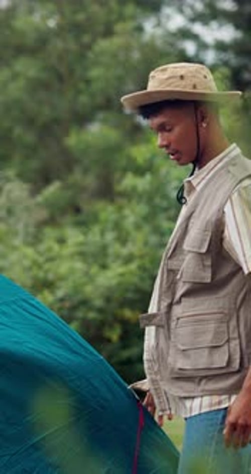 Couple, camping and high five for success with tent in nature for travel, vacation and holiday