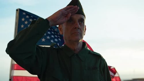 Man Salutes American Flag in Army Uniform