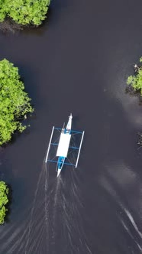 Wooden Boat Navigating Waterway Surrounded By Mangroves Siargao Philippines