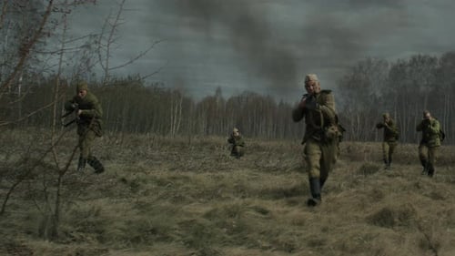 People in Military Garb Run Through Field