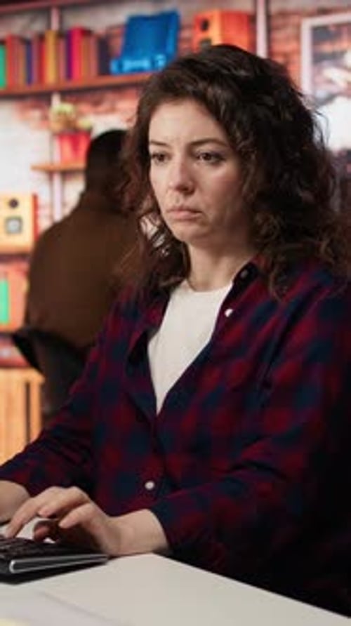 Vertical Video Woman Using PC in Startup Office to Design and Implement Algorithms