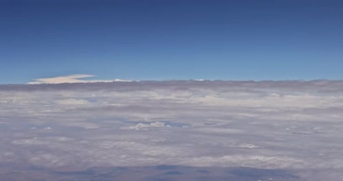 View From the Plane Window of a Beautiful Natural Landscape with White Clouds in a Blue Sky
