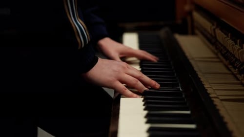 Close-up of Hands Playing a Piano