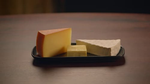 Delicious Cheese Assortment on Black Plate