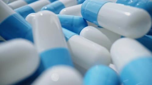 Pile of Blue and White Medicine Capsules