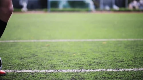 Soccer player skillfully maneuvering the ball on the green football field