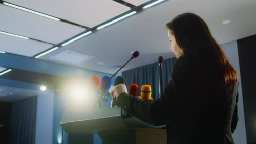 Woman Speaking at Podium in Corporate Setting