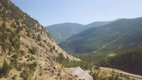 a highway in colorado with a amazing mountain vista and busy traffic
