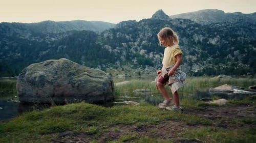 Cute and Cheerful Child Girl Walk on Beautiful Mountain Landscape at Vacation
