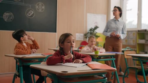 School Class Lesson Children Studying Learning in Classroom Woman Teacher Female Tutor Walking