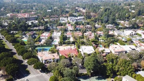 Upscale american residential area with villas in Beverly Hills. Summer day with private tennis field