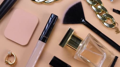 Rotating Background with Decorative Cosmetics and Bijouterie Chain Bracelet and Earrings or Clips or