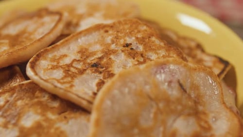 Rotating Plate with Strawberry Fritters Pancakes Close Up Top View