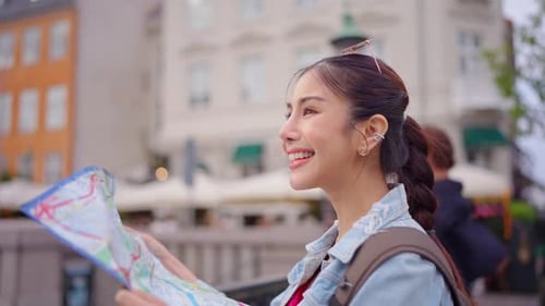Woman Tourist Navigating City with Paper Map