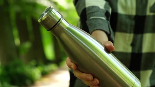 Closeup of Unrecognizable Female Hand Holding Water Bottle