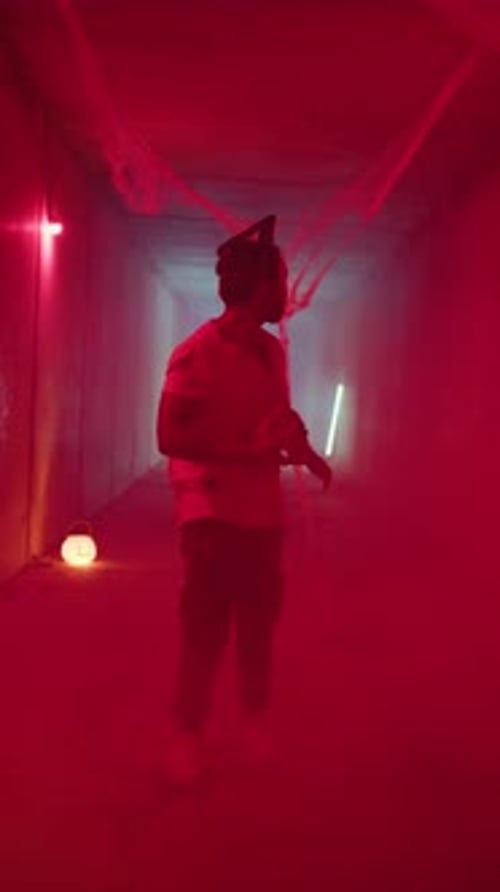 Man in Halloween Mask in Decorated Hallway