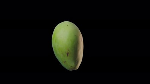 Vibrant Green Mango Rotating on Black Background