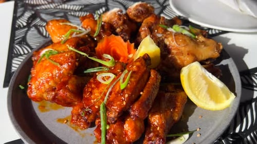 Hot and spicy chicken wings in sticky bbq sauce with spring onion and lemon slices, Asian cuisine, 4
