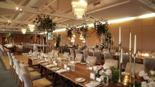 Formal indoor event table setting, flower decor and chandeliers