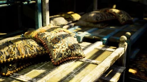 Decorative Ornate Cushions with Pom-Poms on a Rustic Display
