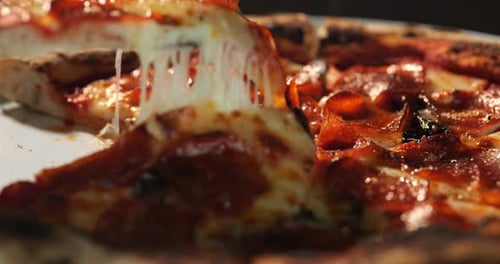 Slice of Pepperoni Pizza with Melting Cheese