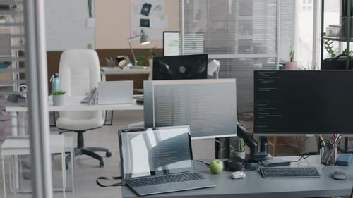 Interior of Modern IT Office with Codes on Computer Monitors