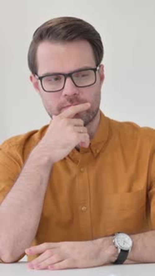 Young Man Thinking in Office, Vertical Video