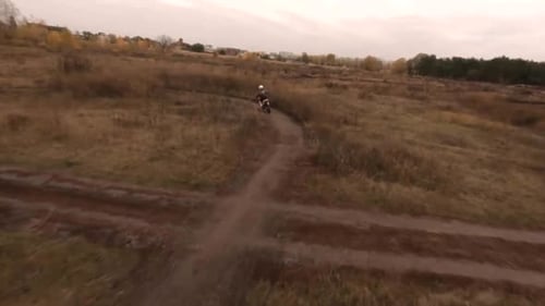 Dirt Bike Riding Along Rural Winding Path