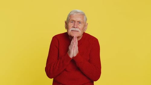 Senior Man Gesturing on Yellow Background