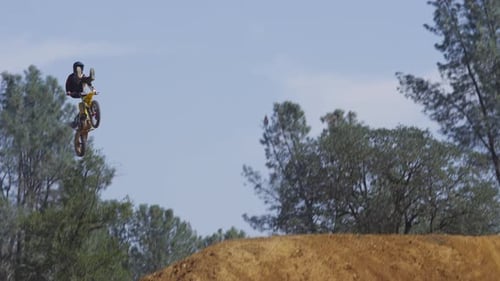Dirt bike rider jumps at outdoor Motocross park