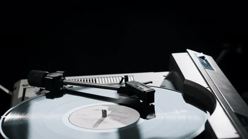 Vinyl Record Spinning on a Silver Turntable