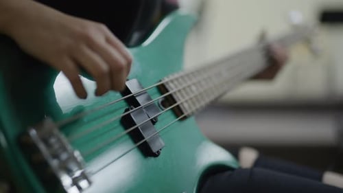 Rocker girl learning guitar in school