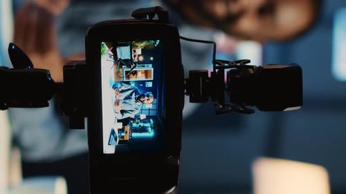 Camera View of Man Video Conferencing at Desk