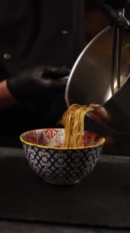 Chef Prepares Noodle Dish, Pours Broth