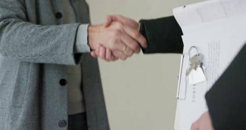 Estate Agent Shaking Hands with His Customer After Contract Signature