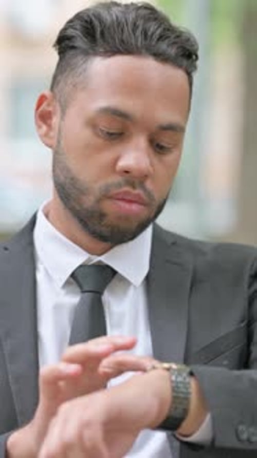Man in Suit Checking His Watch Outside