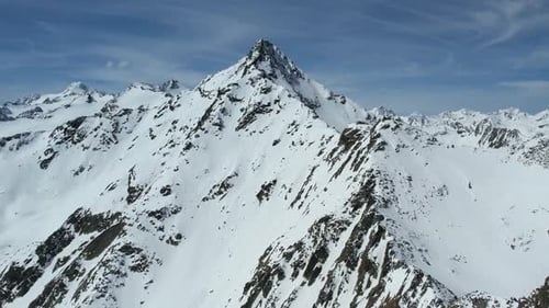 Aerial drone view of snow mountains in winter at a ski resort
