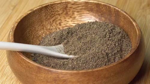 Ground Black Pepper in Wooden Bowl