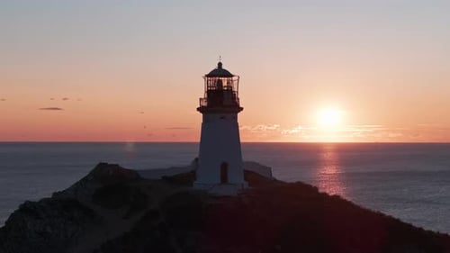 The Guiding Beacon A Majestic Lighthouse Perched on a Cliff Overlooking the Vast Ocean