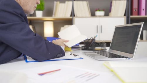 Adult Works at Desk in Corporate Office