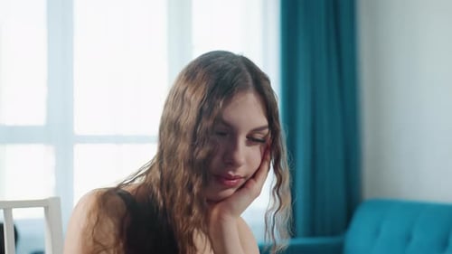 Thoughtful Woman with Wavy Hair Posing Indoors